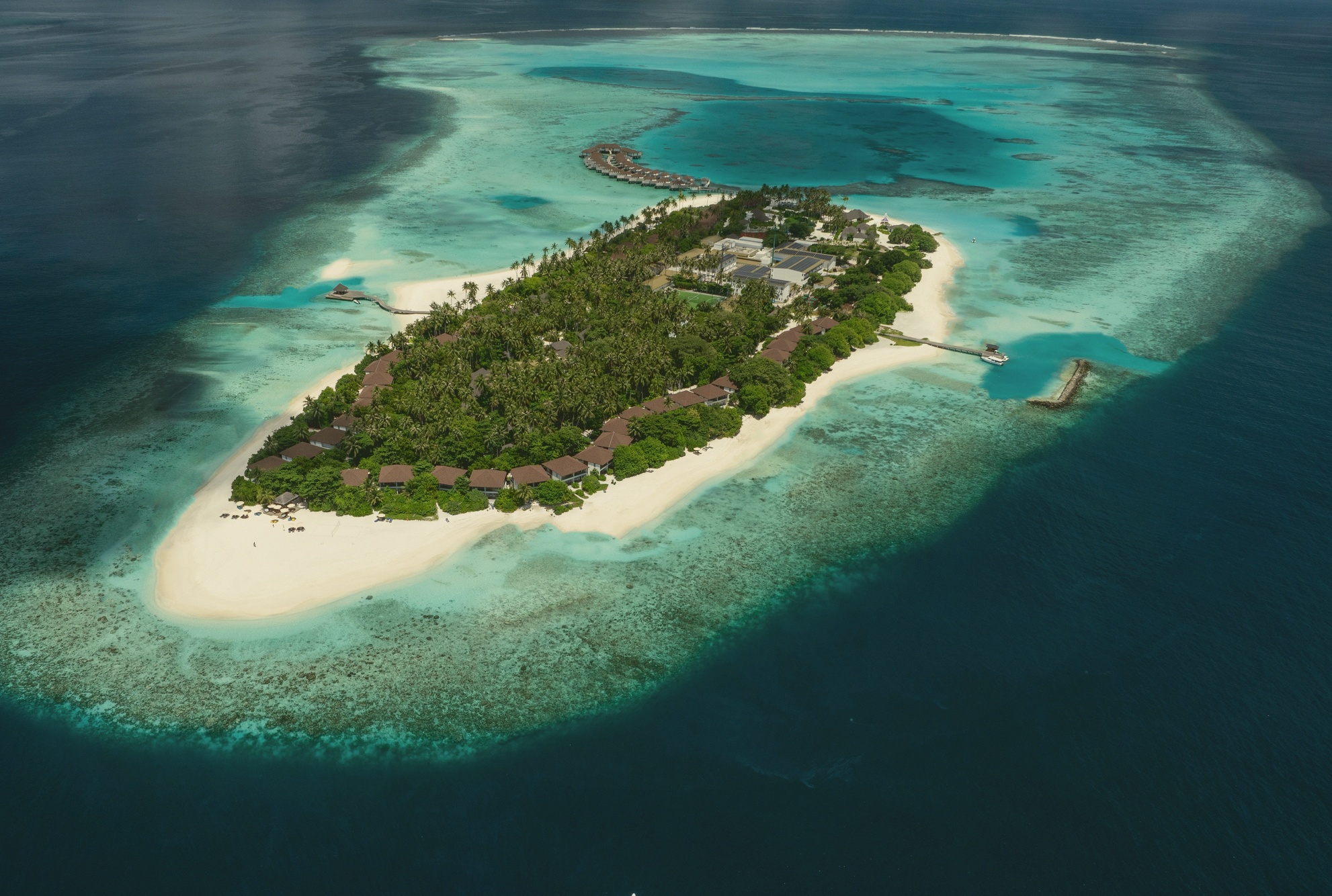 Fares Island from above. The resort occupies its own island in Baa Atoll, with twenty-four villas distributed across beach and overwater positions.