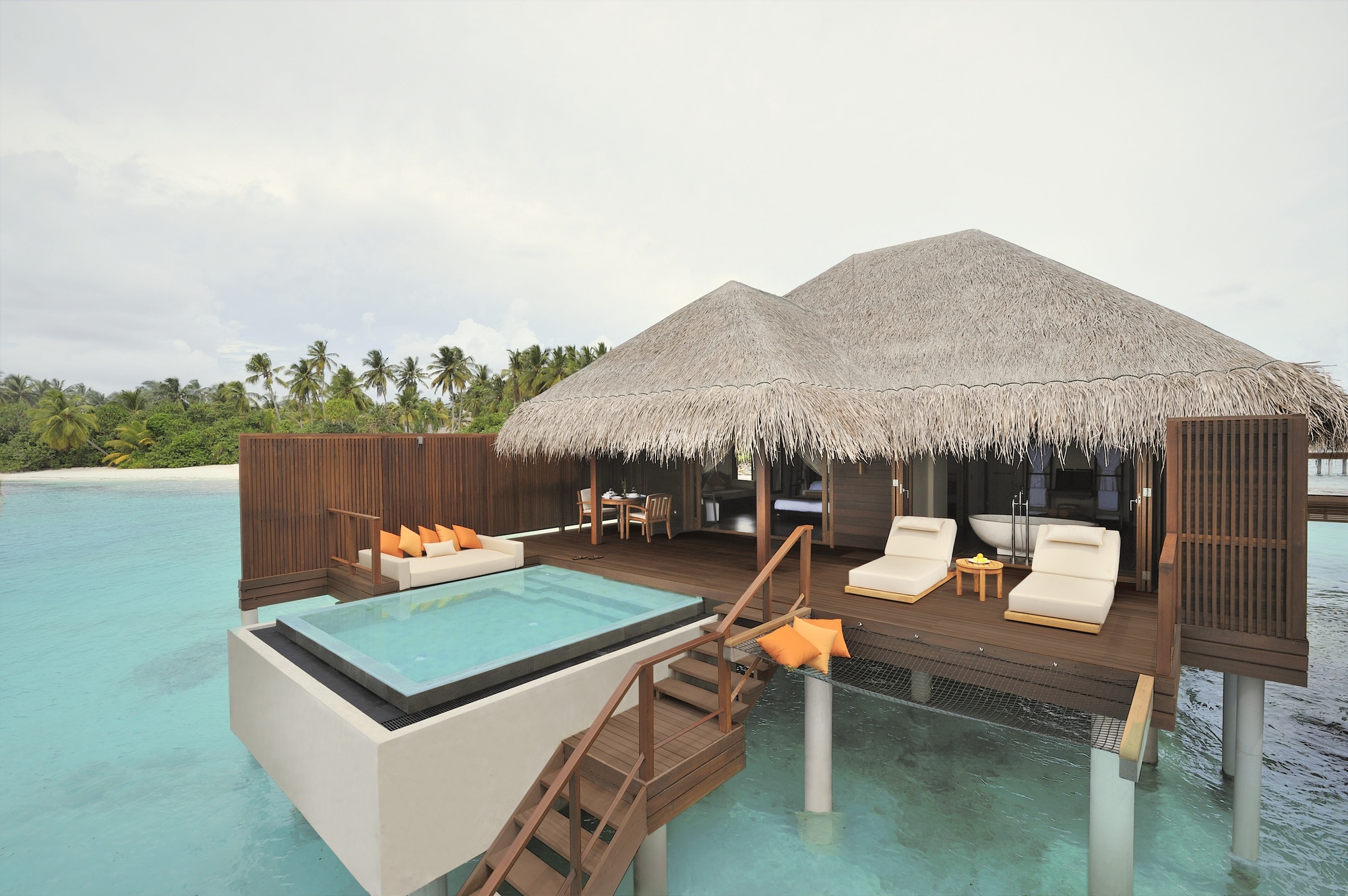 An overwater villa from the deck, looking out across the lagoon. The water in the southern atolls runs clear and sees less boat traffic than the central Malé range.