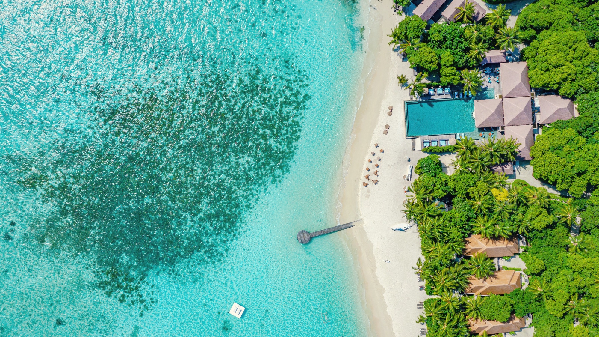 Maguhdhuvaa Island from above. The resort occupies its own private island in Gaafu Dhaalu Atoll, scaled to 107 villas across a single landmass at the southern edge of the archipelago.