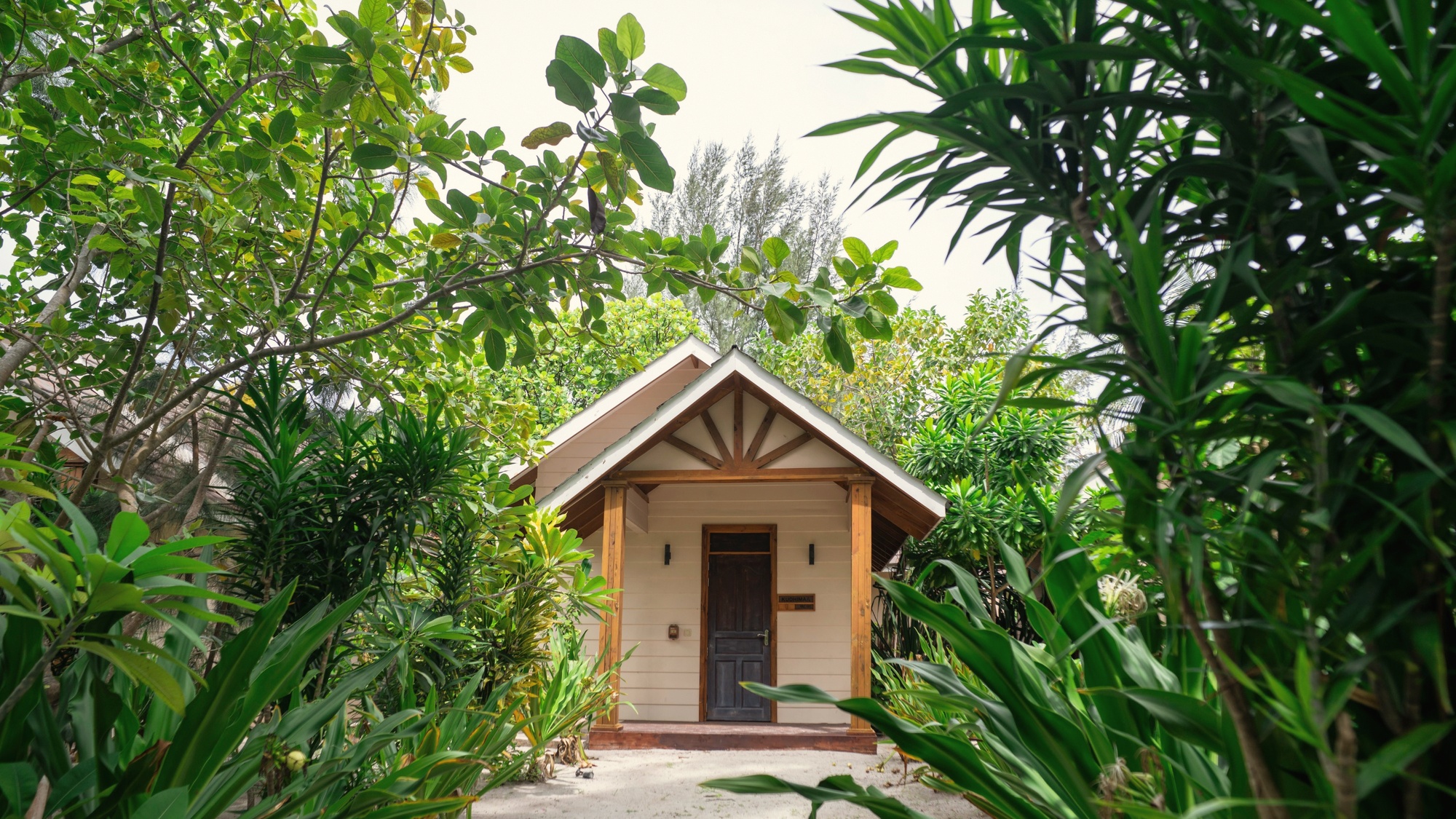 The spa treatment room. A single bed, open louvres, and the sound of the lagoon audible from inside.