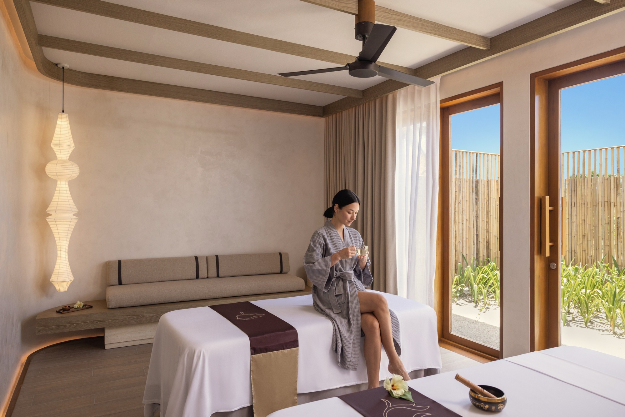 The spa and wellness facilities. Treatment rooms positioned over the water, with natural light and lagoon views throughout.