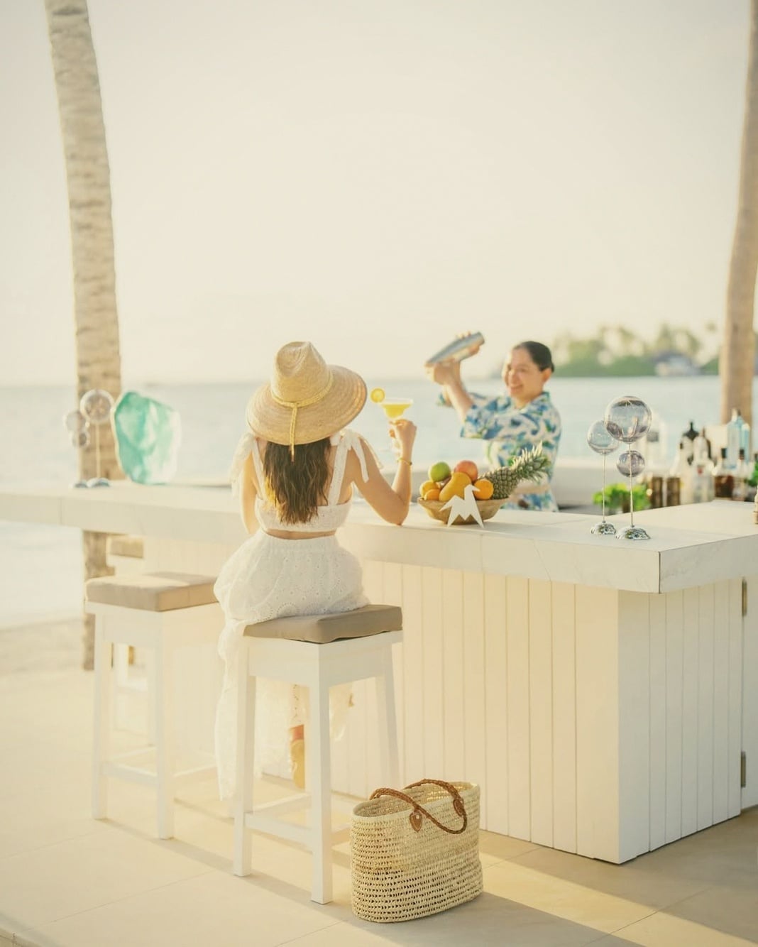 The White Bar at sunset. The property's main social space, deliberately small in scale relative to the larger Maldives alternatives.