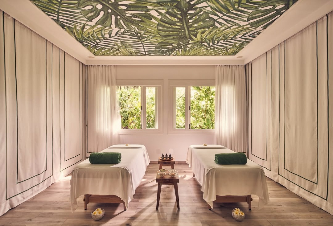 The spa treatment room or pool terrace. Calm, shaded, away from the main beach club energy.