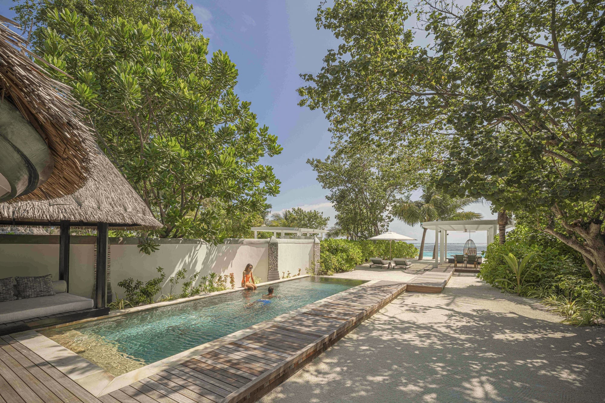 Beach pavilion deck. Kuda Huraa's signature beach configuration, well-finished within the operational simplicity of the speedboat-only access.