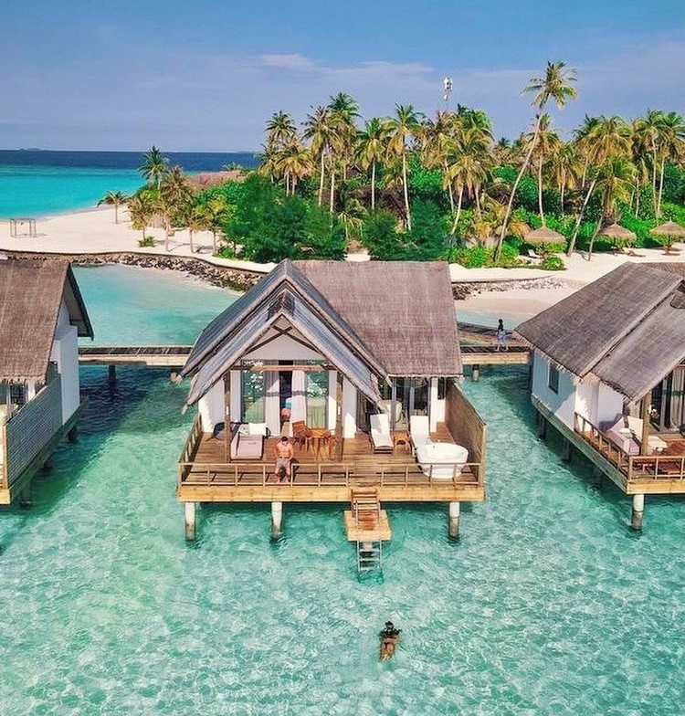 An overwater pool villa from the deck. The lagoon edge is its own room, with direct reef access below.