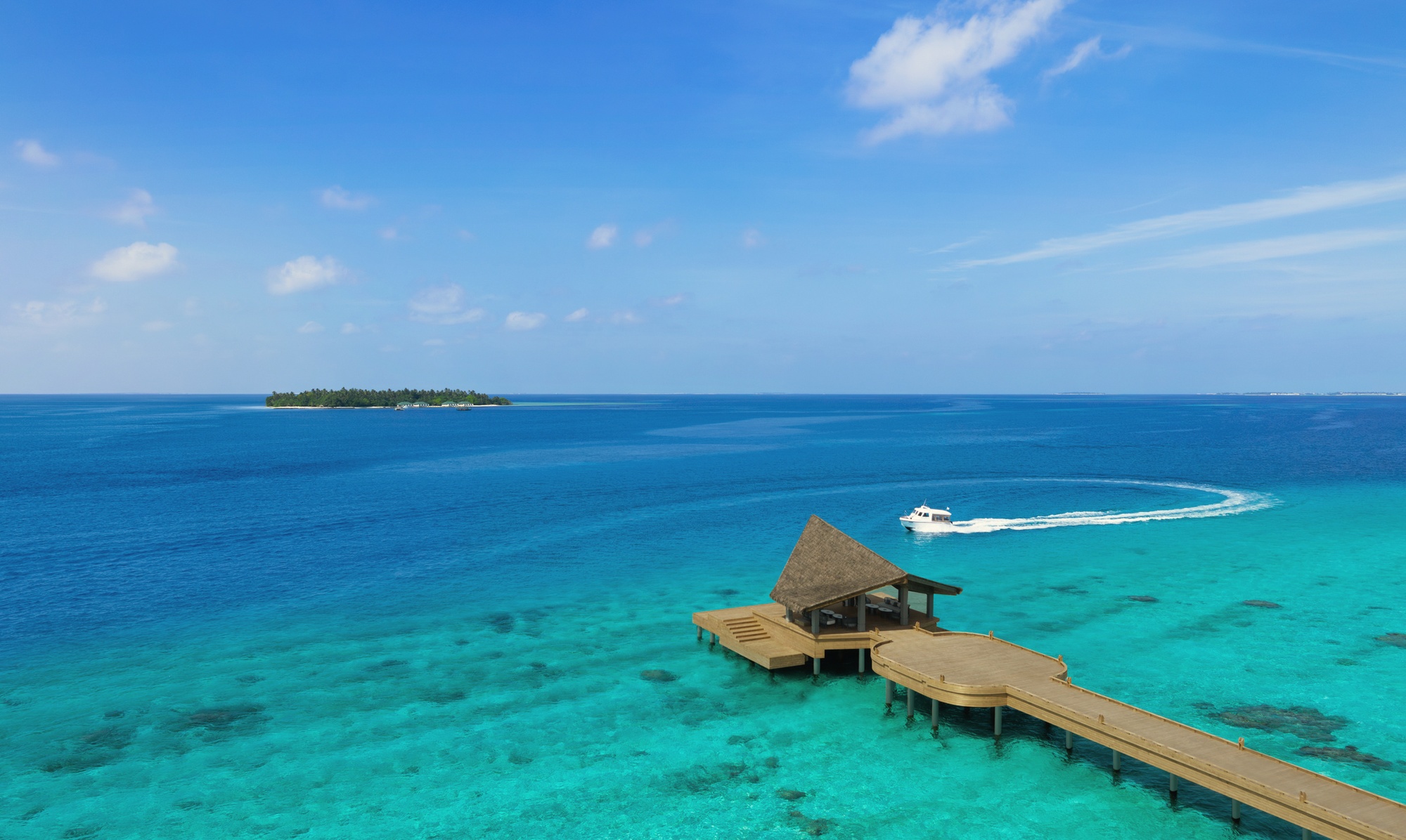 The speedboat arrival jetty. Three minutes from Velana International, the transfer is the shortest of any overwater resort in the OV portfolio.