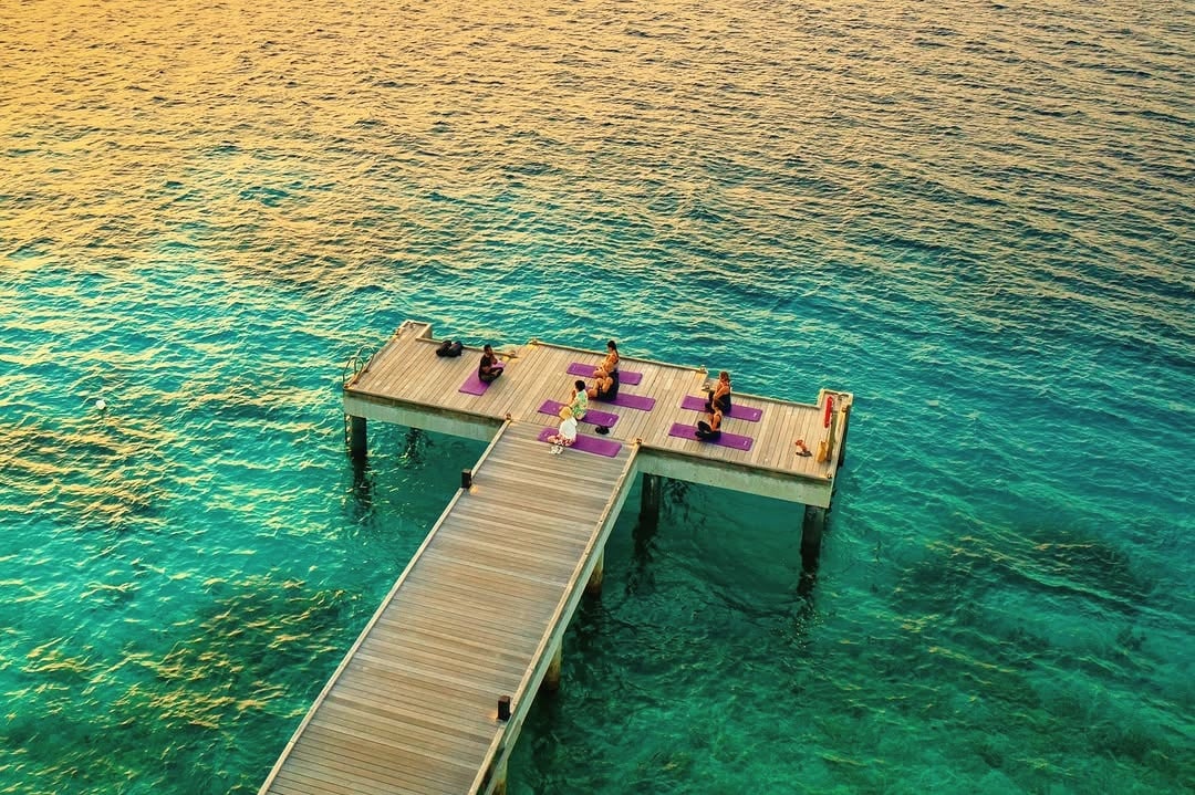 Yoga deck at sunrise. Kagi's wellness day starts with the morning practice on the western shoreline.