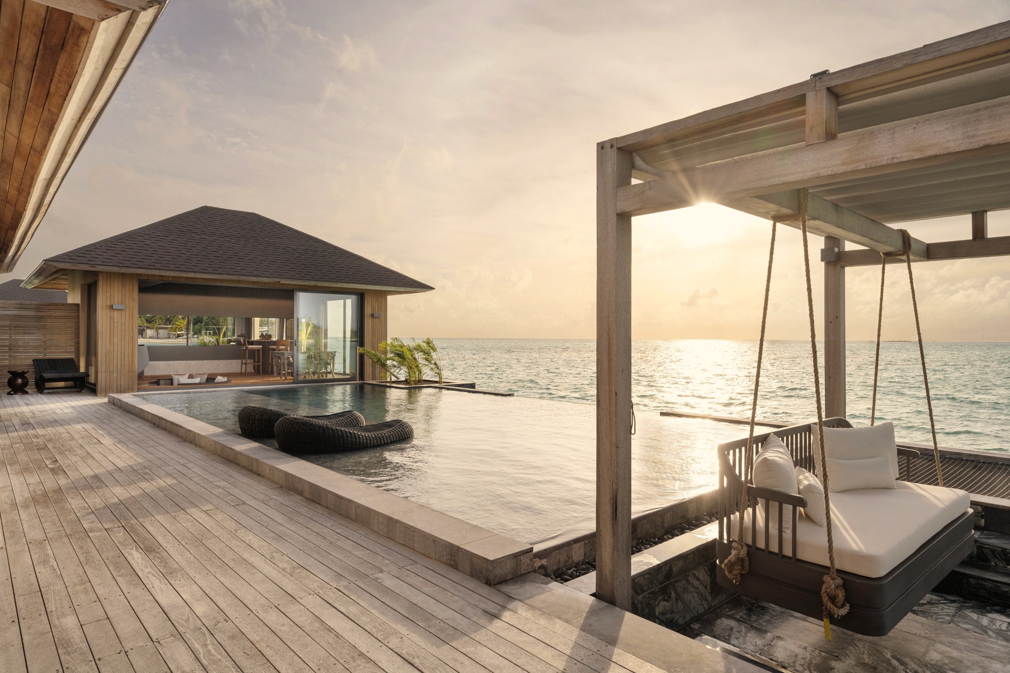 Inside a sunset aqua pool villa. The pool faces west, and the quality of light in the late afternoon is the reason guests choose this category over its sunrise counterpart.
