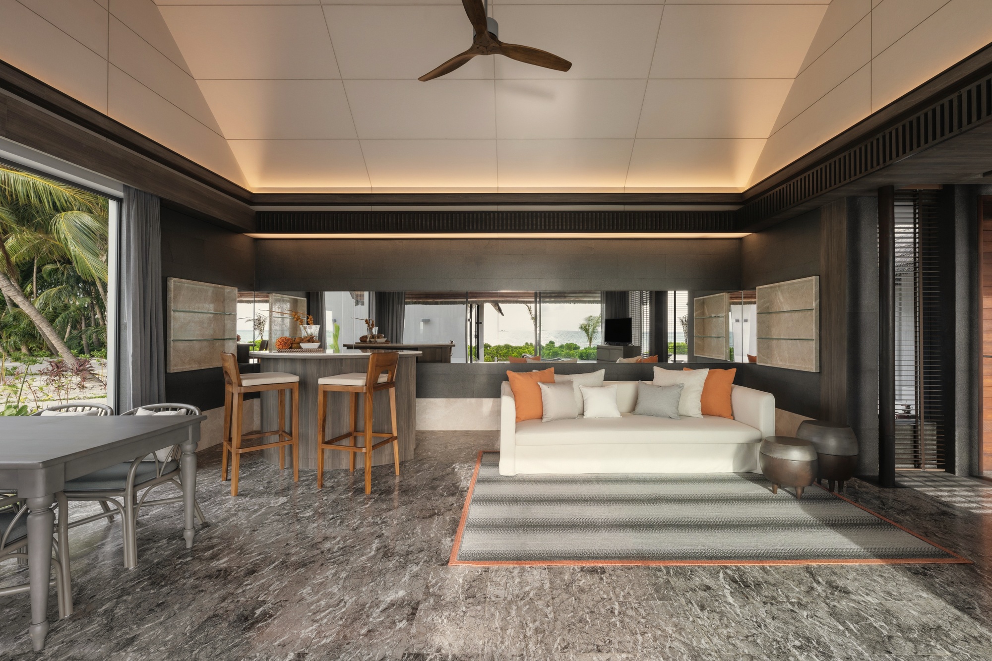 The two-bedroom villa from the garden side. A configuration that works for small families or two couples, with enough separation between the sleeping areas to make the stay comfortable.