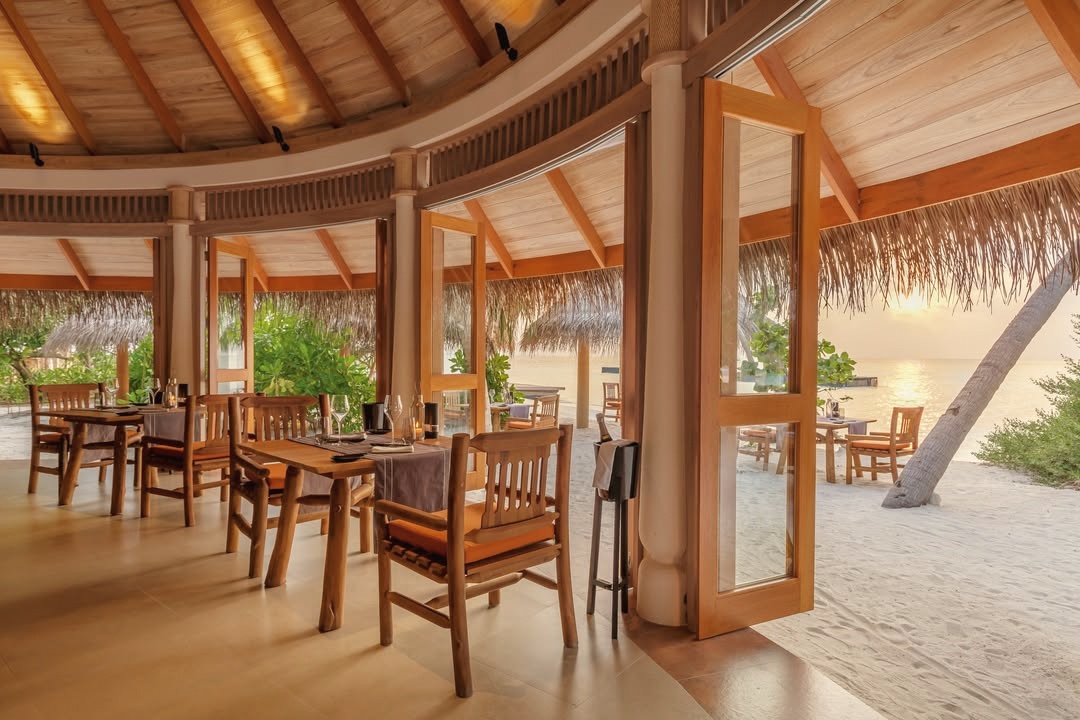 Dining on the water. The over-water restaurant at Milaidhoo, set above the lagoon at the edge of the reef.