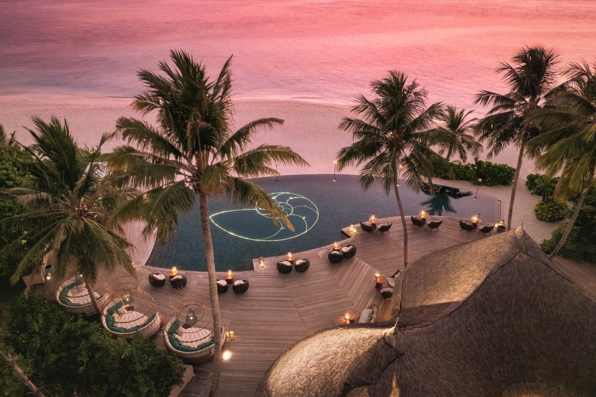 The Nautilus from above. Seven villas occupy a single private island in Baa Atoll, the scale immediately legible from the air.