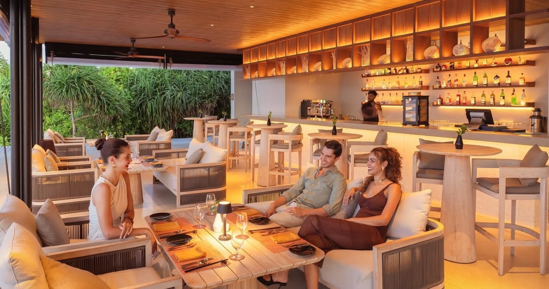 The main dining pavilion at Raaya. Open-sided, set above the water, with the atoll horizon as the backdrop for every meal.