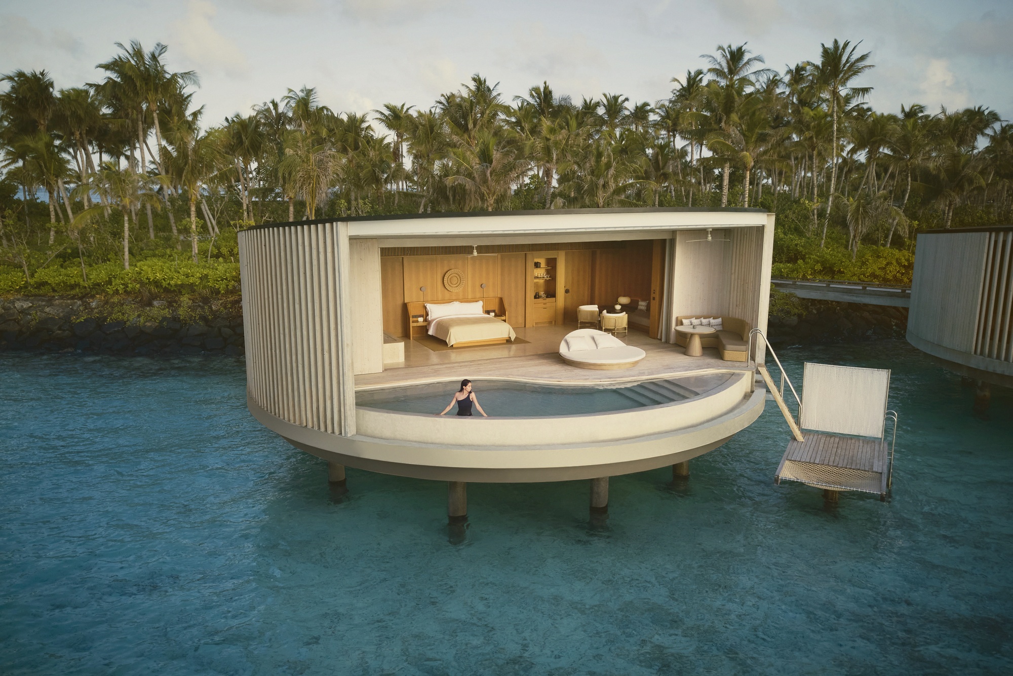 The signature Ocean Pool Villa exterior. A private pool at the water's edge, with the cove framing the outlook on three sides.