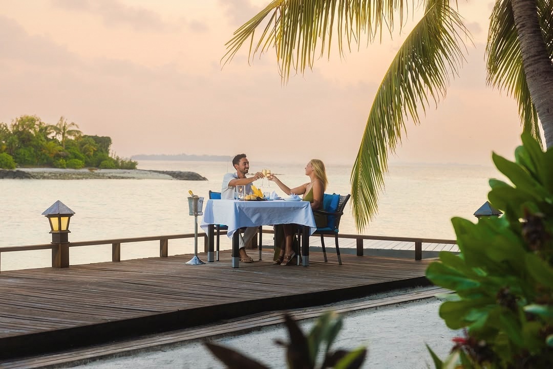 An evening dining setting on the water. The resort's restaurant strip faces west, and the light at the end of the day is the occasion.