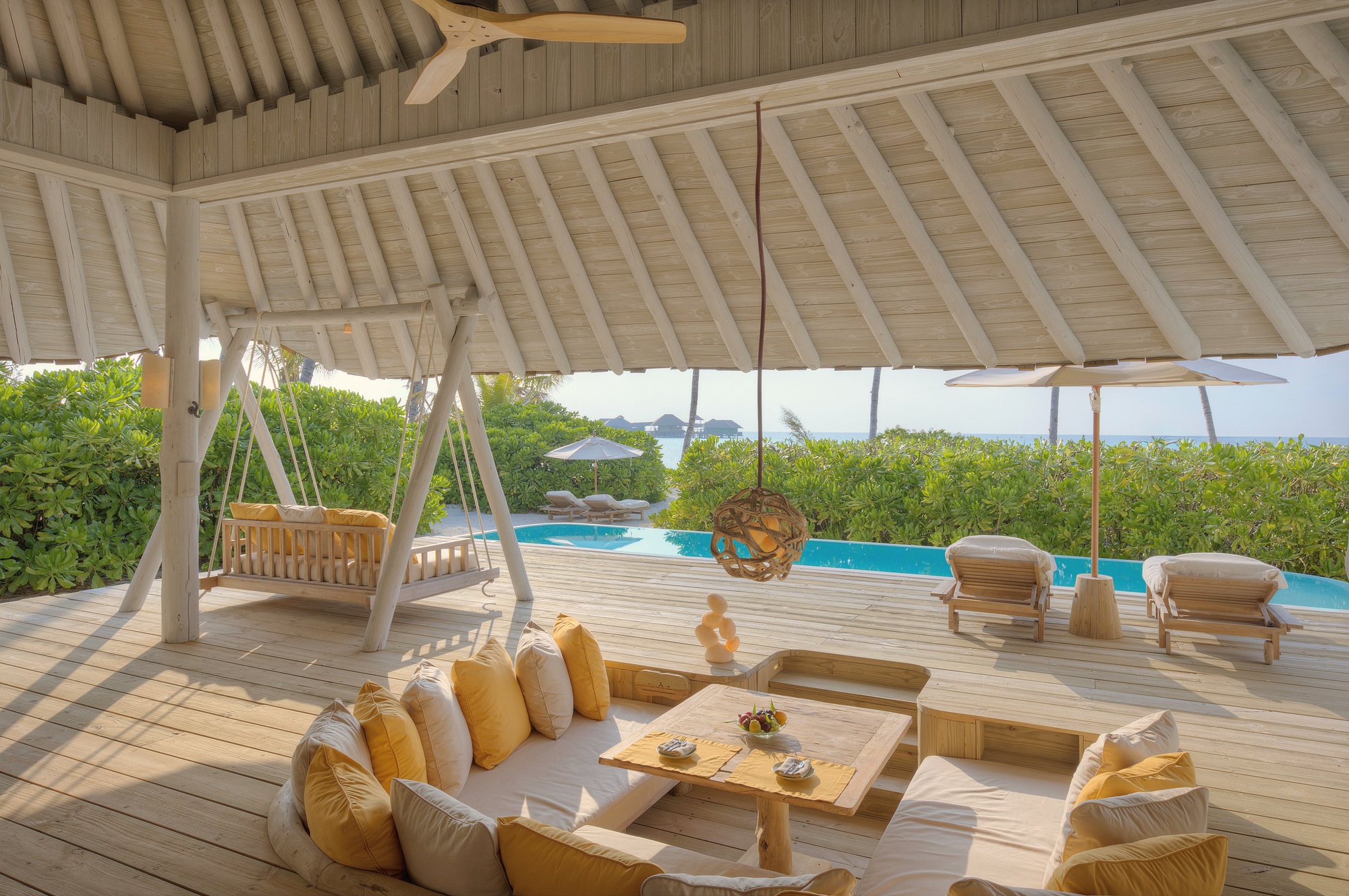 The interior of a beach villa. Soneva's material palette runs to natural fibres, open-air bathrooms, and the kind of finish that does not announce itself.