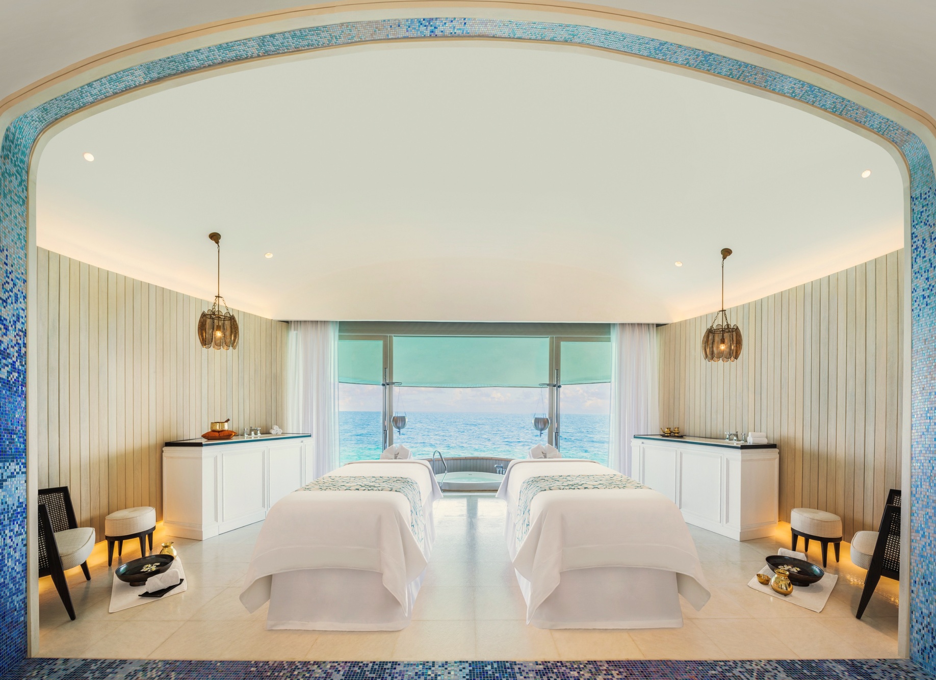The spa treatment room. The wellness facilities are positioned within the island's vegetation, separated from the villa zone.