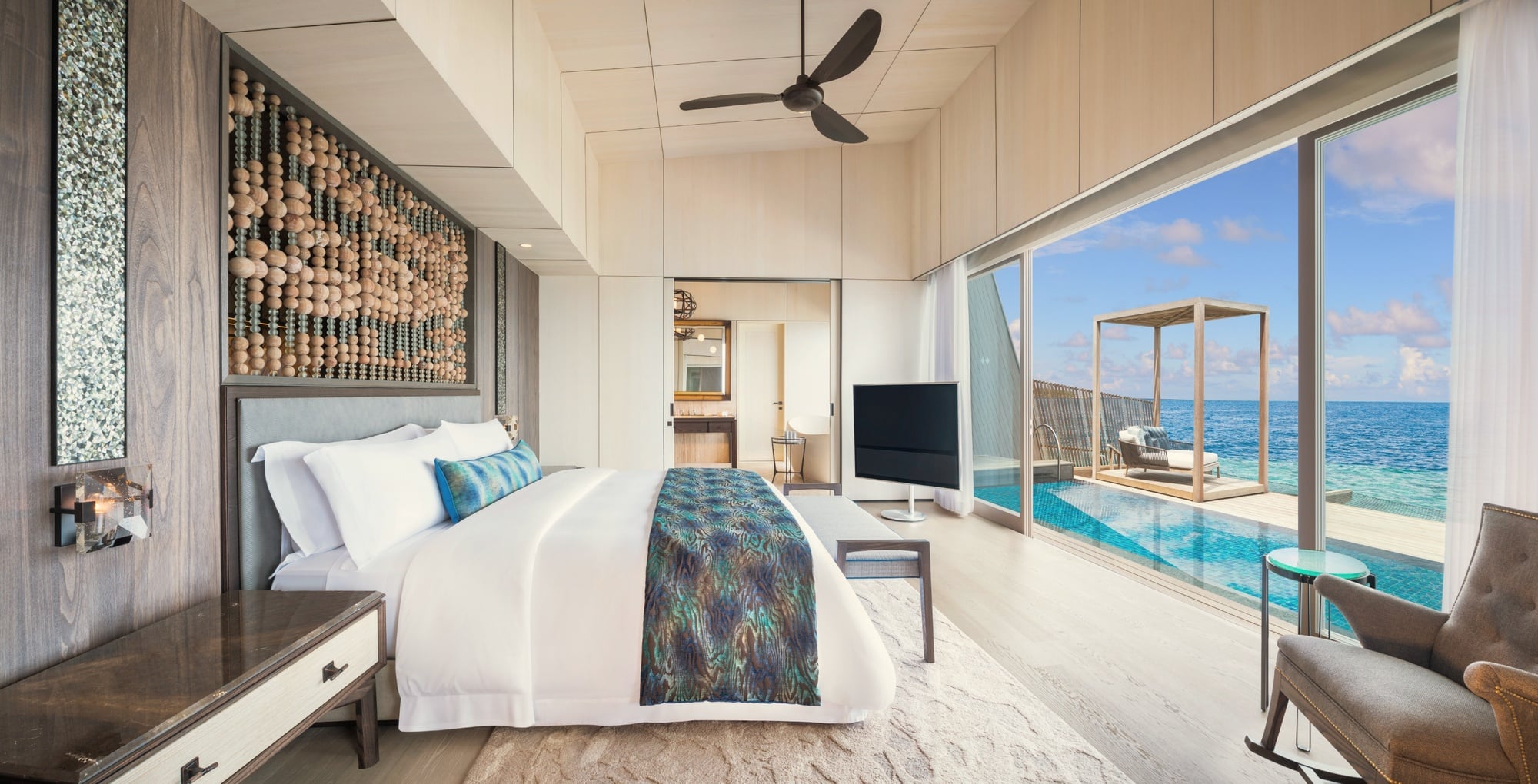The villa interior. St. Regis-standard finishes, generous proportions, and a private pool at the lagoon edge.