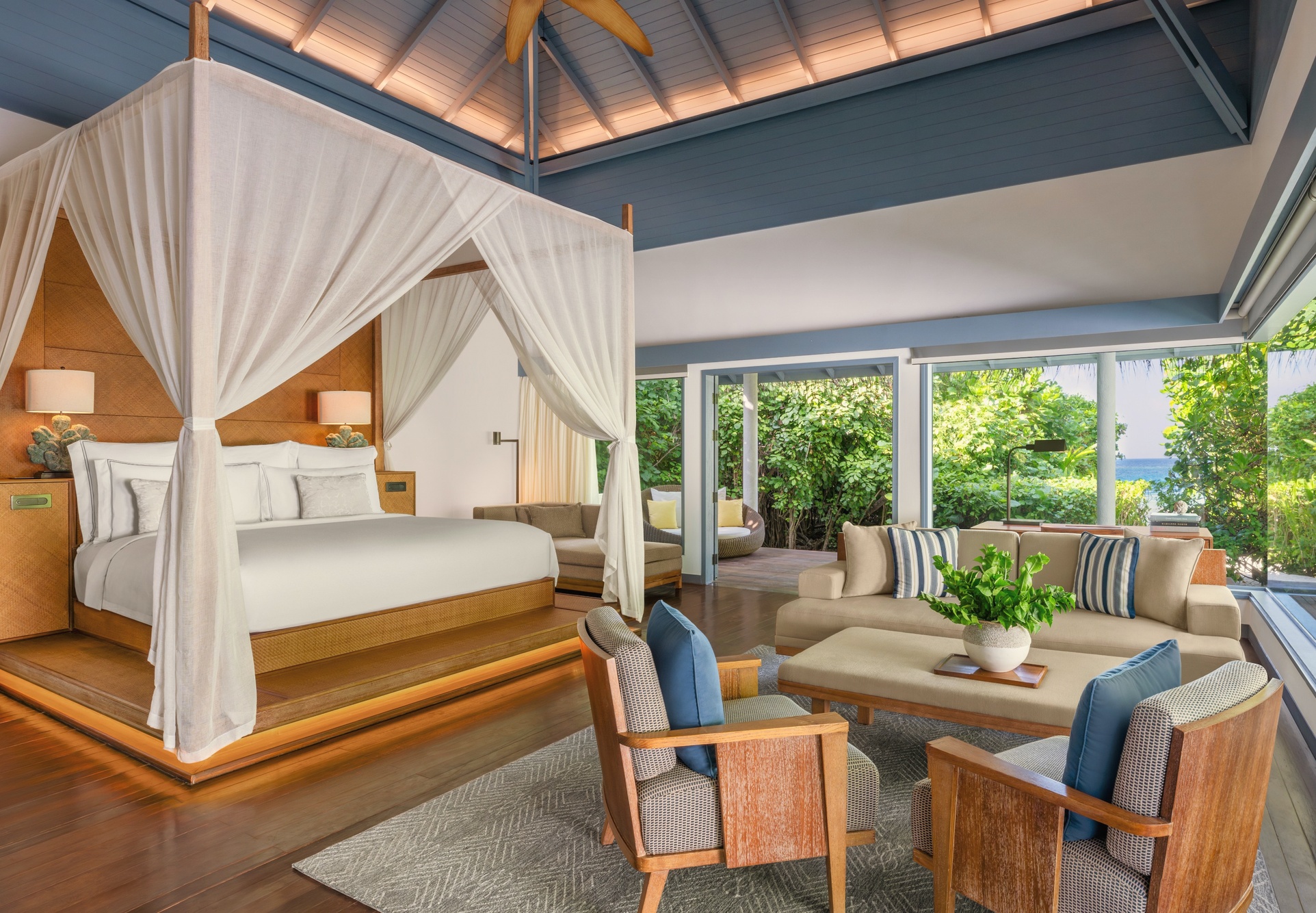 Inside a Beach Pool Villa. Warm timber, high ceilings, and a pool deck that extends the living space toward the lagoon edge.