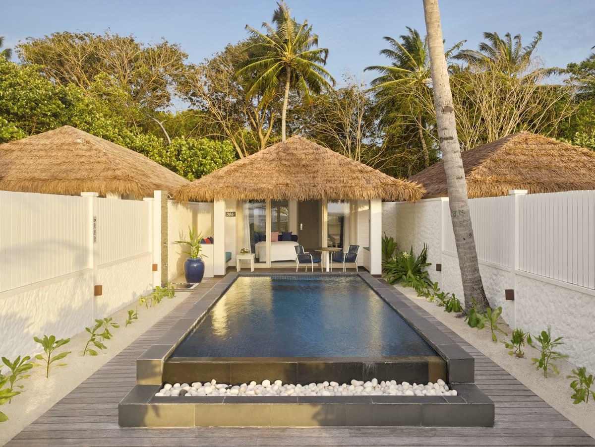 The lagoon edge from a Beach Pool Villa. The pool sits between the villa and the beach, with direct sand access beyond.